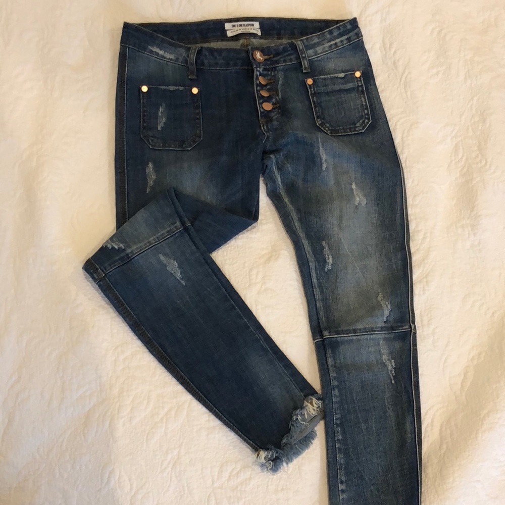Distressed skinny blue jeans